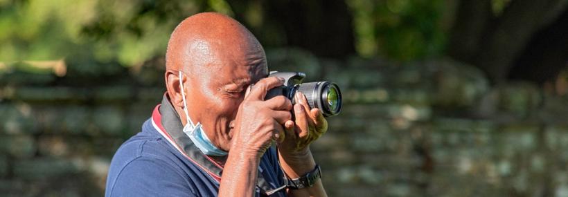 Tretower Court visitor takes photograph in gardens 