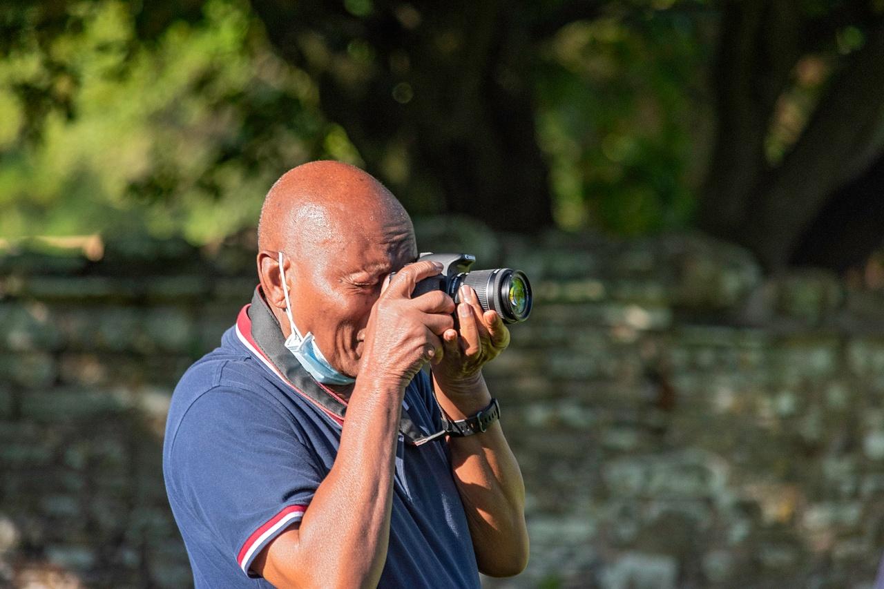 Tretower Court visitor takes photograph in gardens 