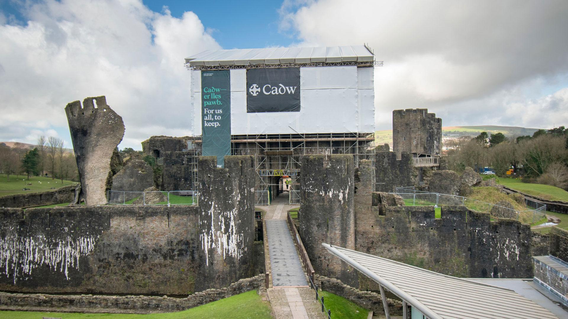 Caerphilly Castle with Cadw branded scaffolding over gatehouse